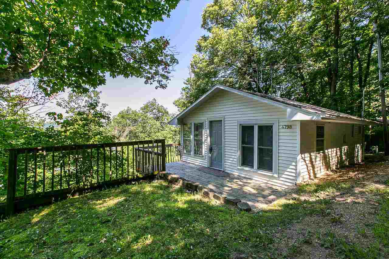 4798 South River Road Hanover, IL 61041 - Photo 1 of 14 a front view of a house with a garden and yard
