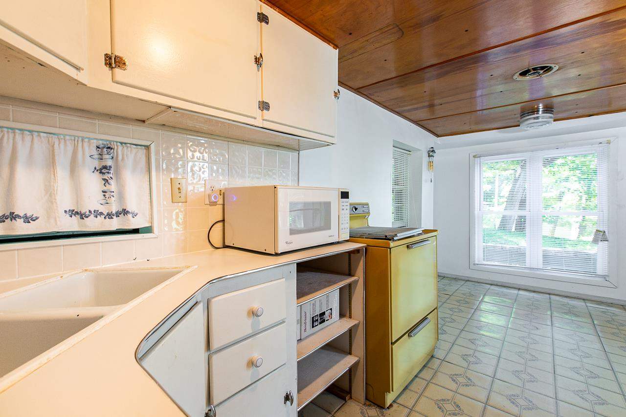 4798 South River Road Hanover, IL 61041 - Photo 12 of 14 a kitchen with cabinets and window