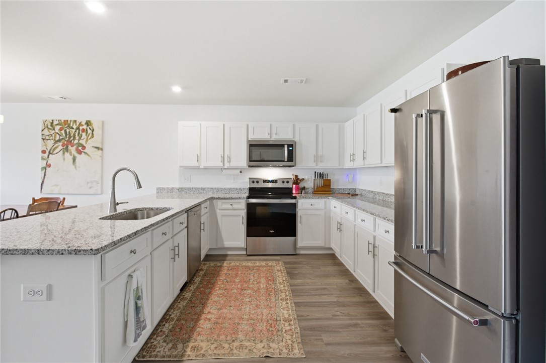 412 Chadwick Lane Walhalla, SC 29691 - Photo 11 of 37 This kitchen showcases light cabinetry and a stainless steel appliance suite for a polished, functional space.