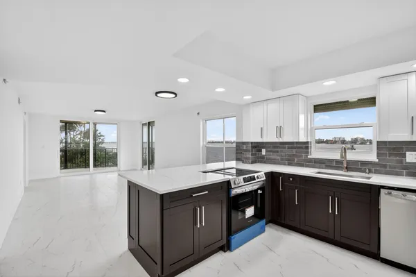 a kitchen with a sink stove and cabinets