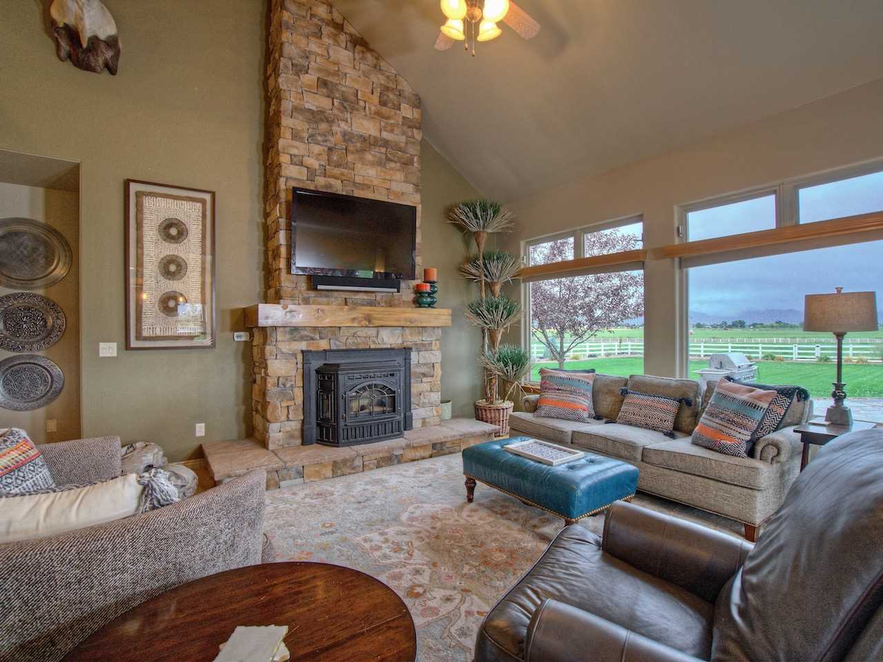 1516 13 Road Loma, CO 81524 - Photo 11 of 32 a living room with furniture large window and a fireplace