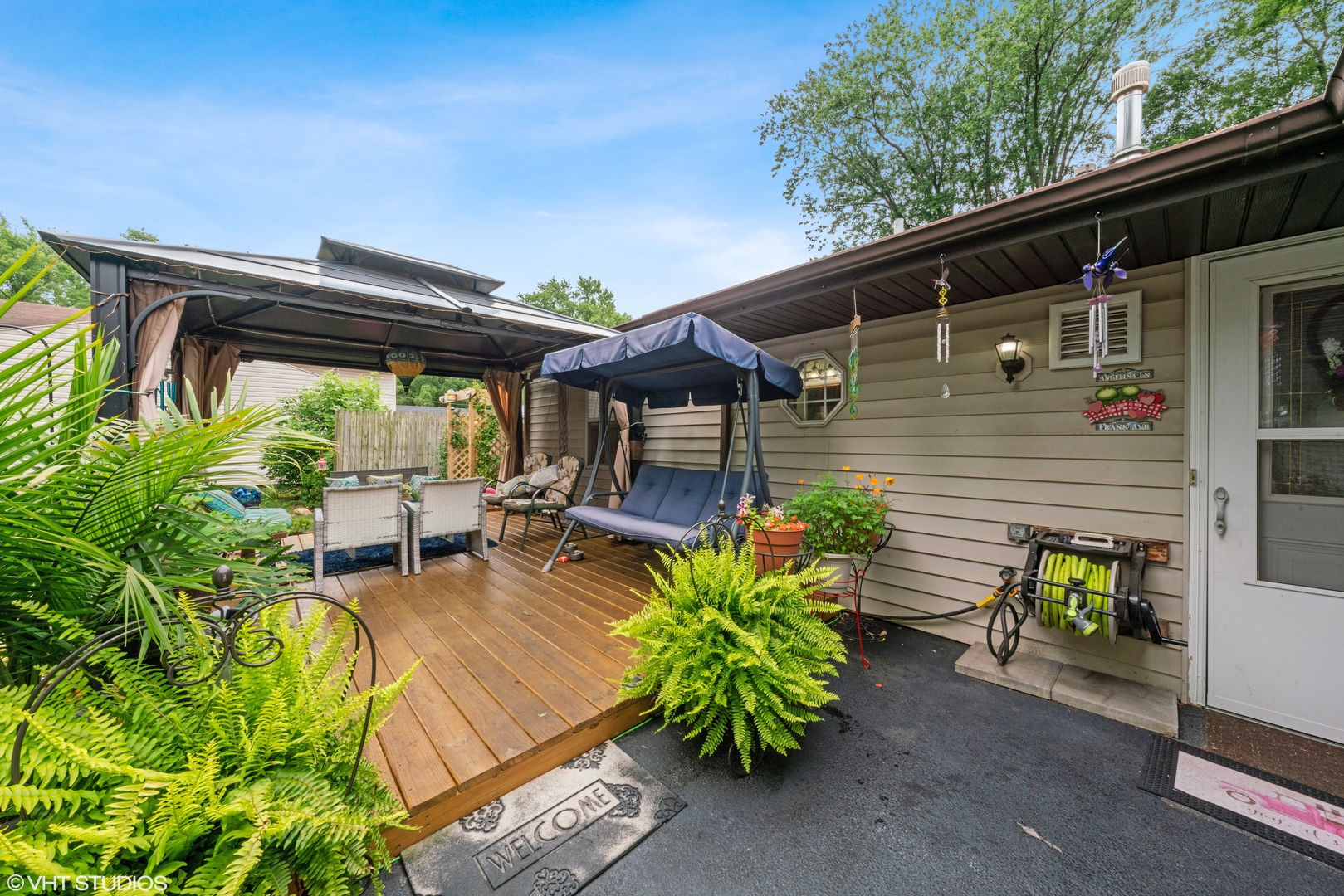 171 Seabury Road Bolingbrook, IL 60440 - Photo 3 of 13 a view of a patio with table and chairs potted plants with wooden fence