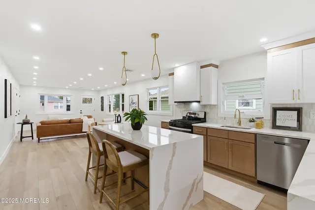 a kitchen with stainless steel appliances kitchen island granite countertop a sink and cabinets