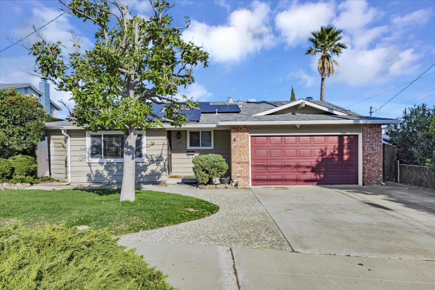 a front view of a house with a garden and yard