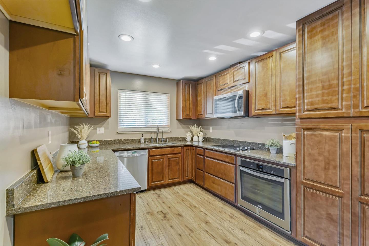363 River View Drive San Jose, CA 95111 - Photo 14 of 41 a kitchen with stainless steel appliances granite countertop wooden cabinets granite counter tops and a window