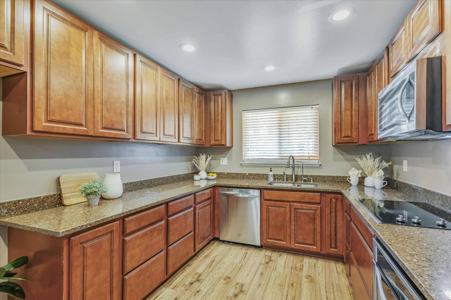 363 River View Drive San Jose, CA 95111 - Photo 15 of 41 a kitchen with stainless steel appliances granite countertop wooden cabinets a sink and dishwasher with wooden floor