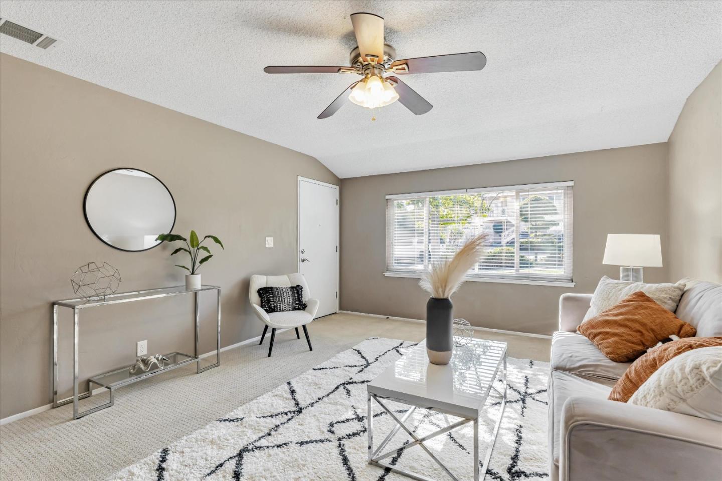 363 River View Drive San Jose, CA 95111 - Photo 7 of 41 a living room with furniture two window and a chandelier