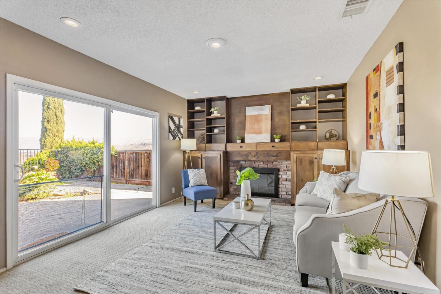 363 River View Drive San Jose, CA 95111 - Photo 9 of 41 a living room with fireplace furniture and a floor to ceiling window