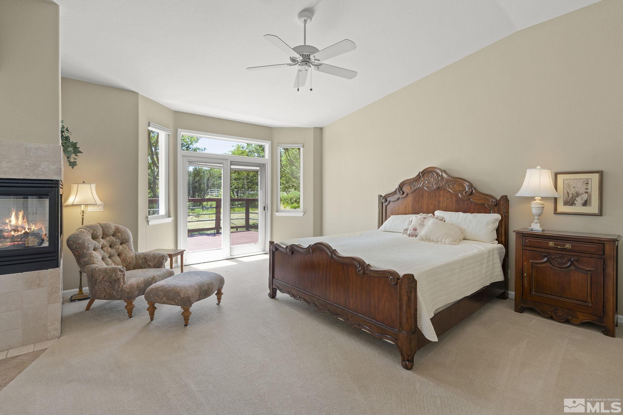 820 Flanders Road Reno, NV 89511 - Photo 17 of 40 a spacious bedroom with a bed and a couch
