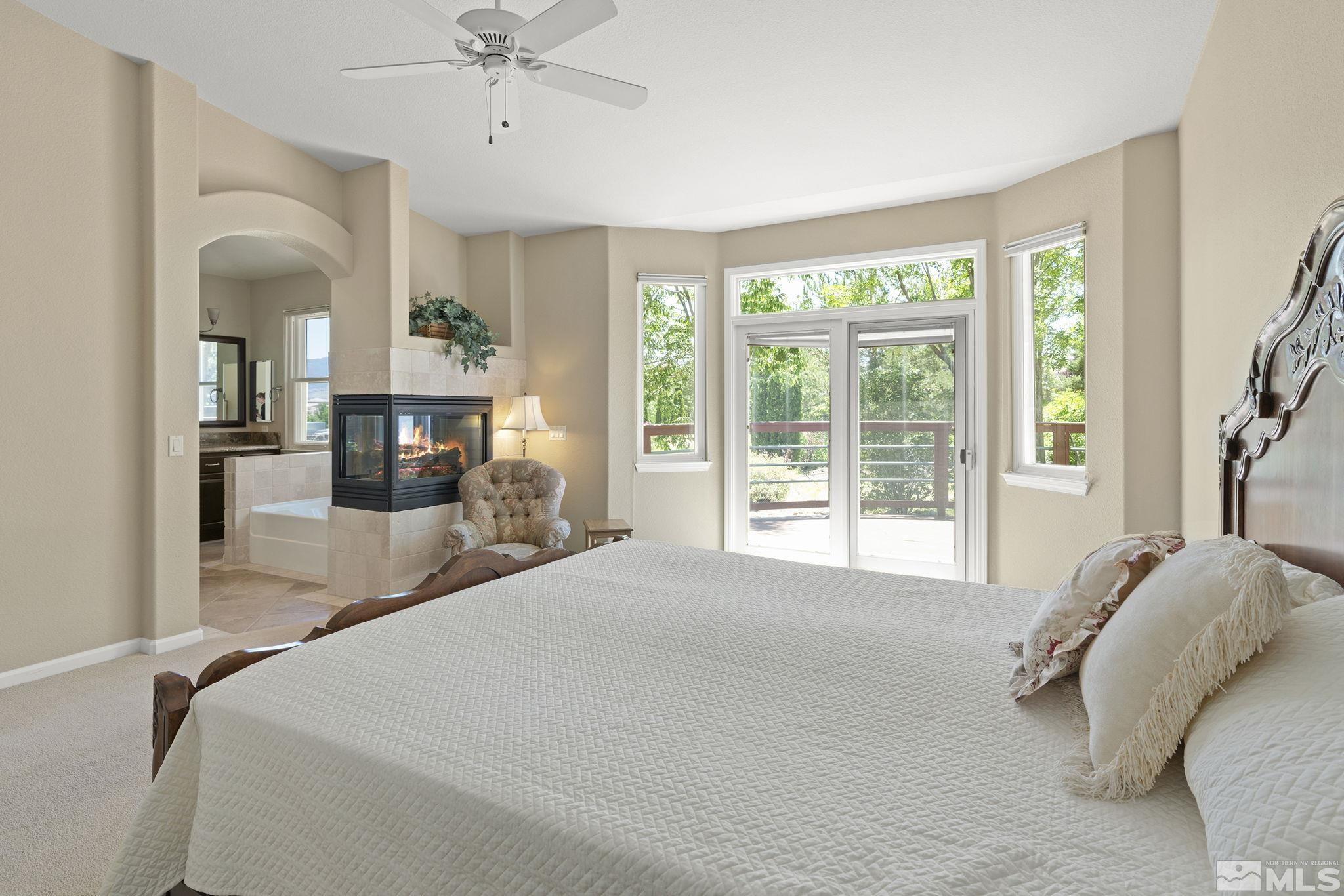820 Flanders Road Reno, NV 89511 - Photo 18 of 40 a bed room with a bed and a fireplace