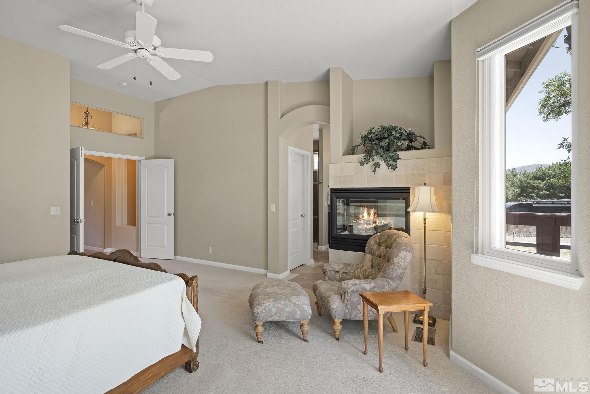 820 Flanders Road Reno, NV 89511 - Photo 19 of 40 a bedroom with furniture and a fireplace