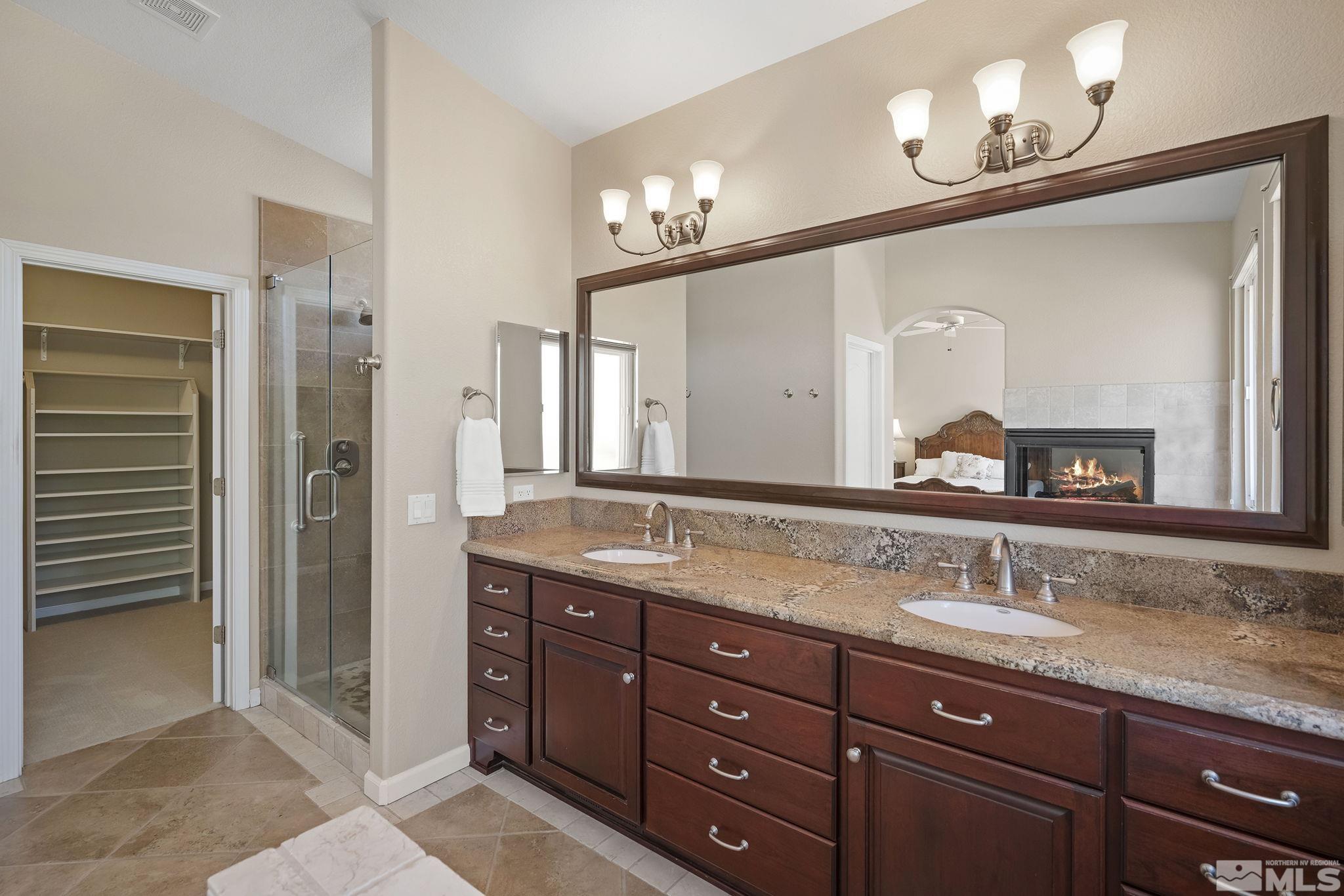 820 Flanders Road Reno, NV 89511 - Photo 21 of 40 a bathroom with a granite countertop double vanity sink and a mirror