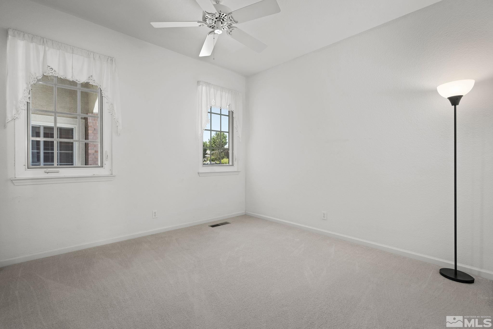 820 Flanders Road Reno, NV 89511 - Photo 27 of 40 an empty room with windows and fan