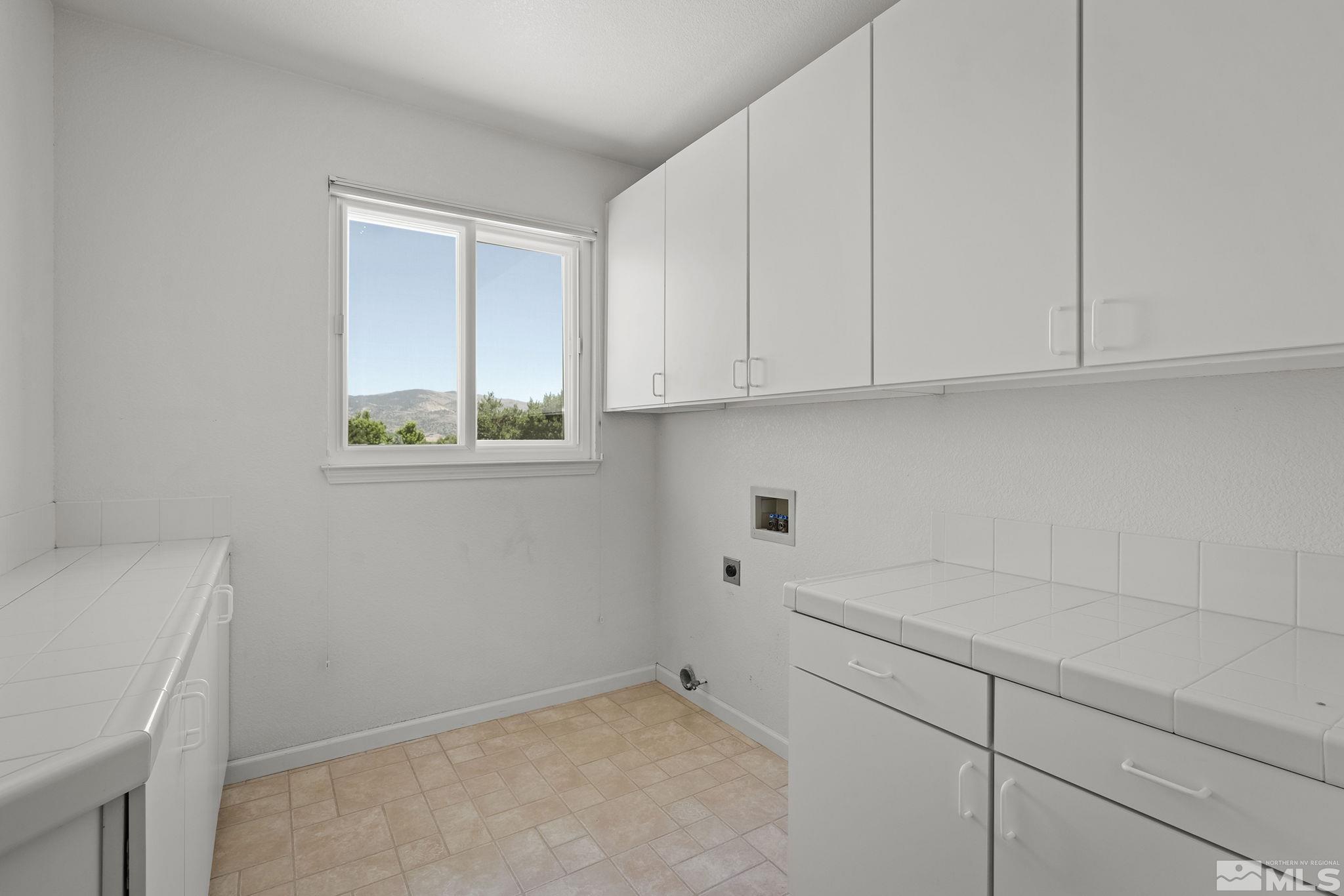820 Flanders Road Reno, NV 89511 - Photo 28 of 40 a view of cabinets and utility room with window