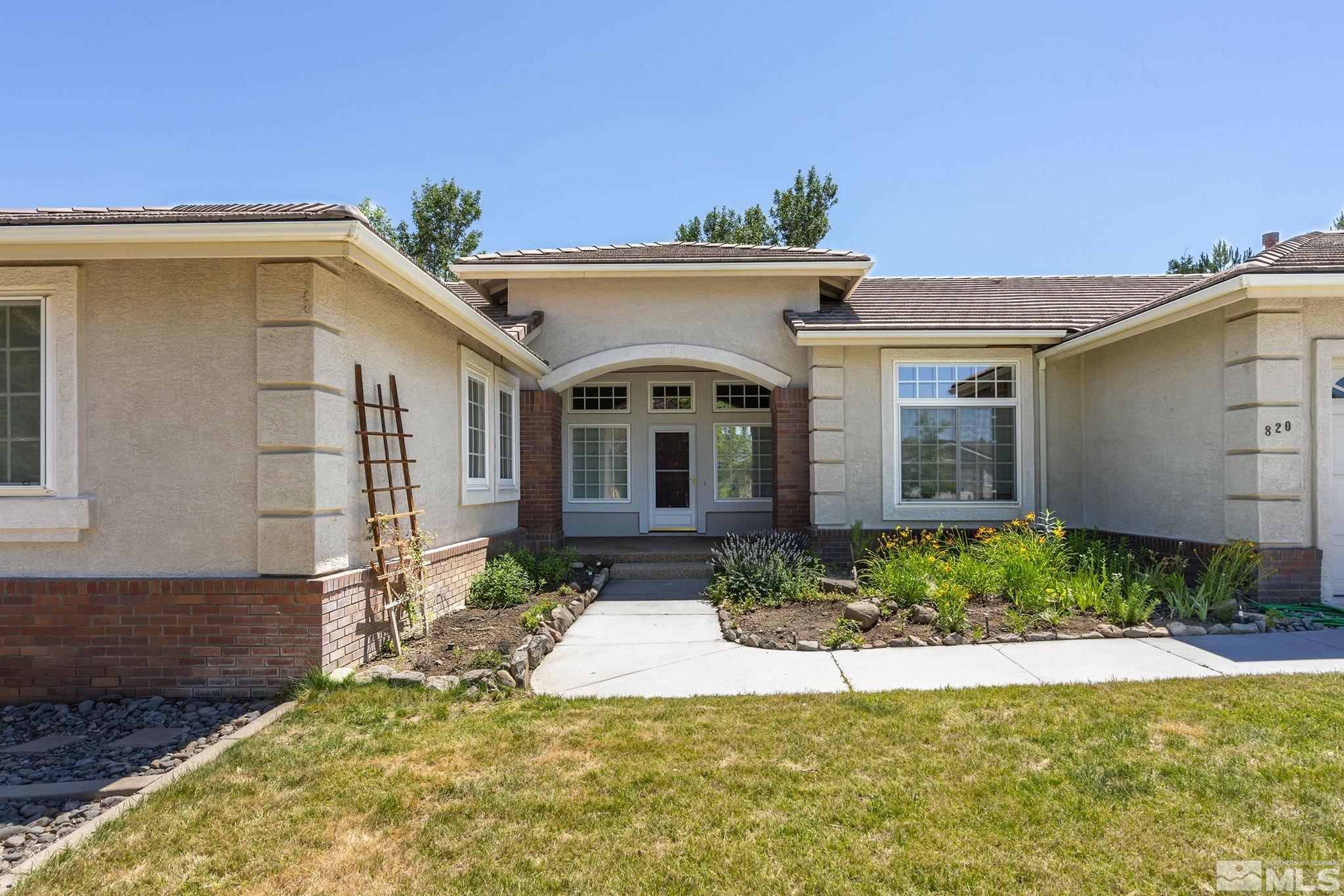 820 Flanders Road Reno, NV 89511 - Photo 3 of 40 a front view of a house with garden