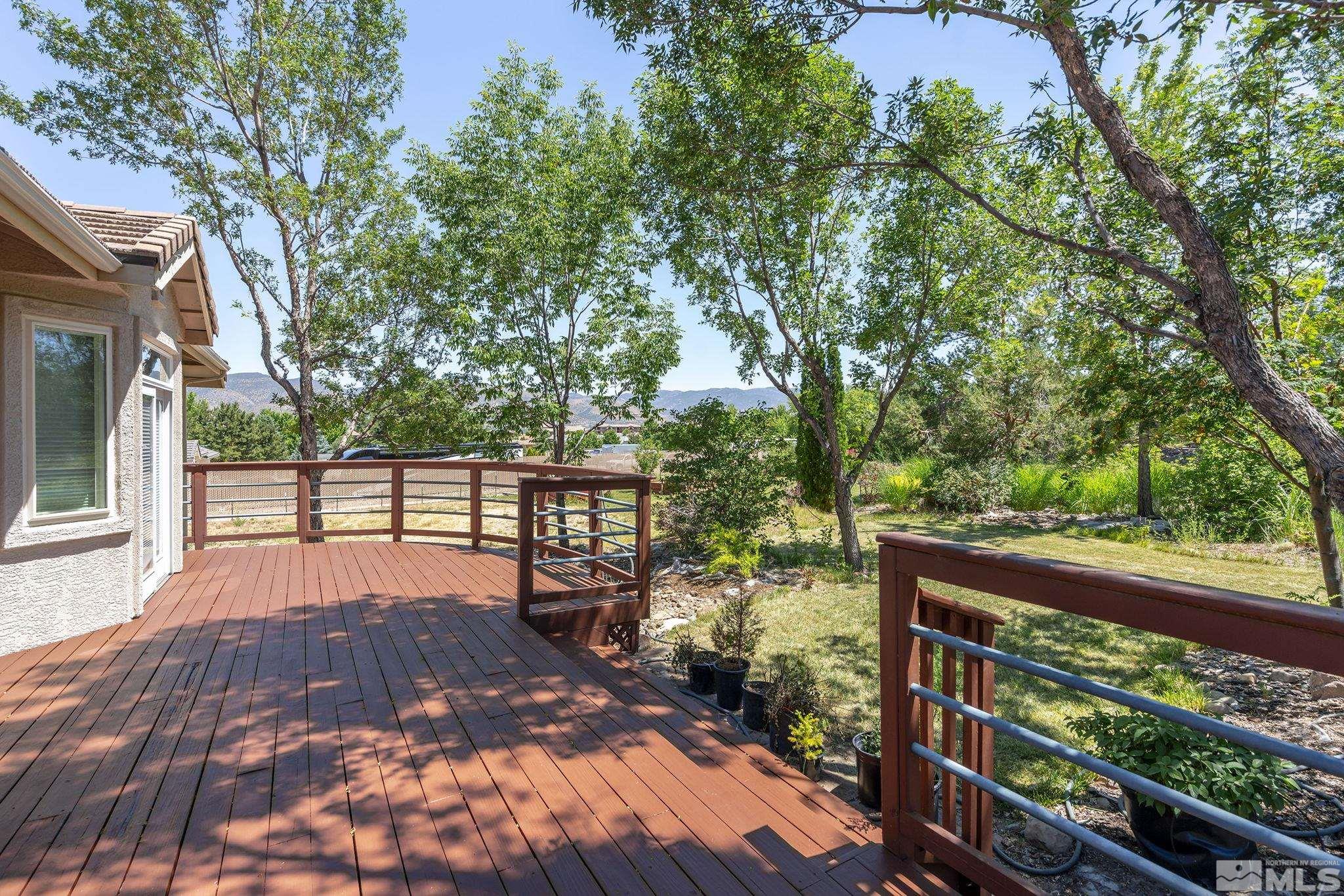 820 Flanders Road Reno, NV 89511 - Photo 35 of 40 a view of a chairs and table on the wooden deck