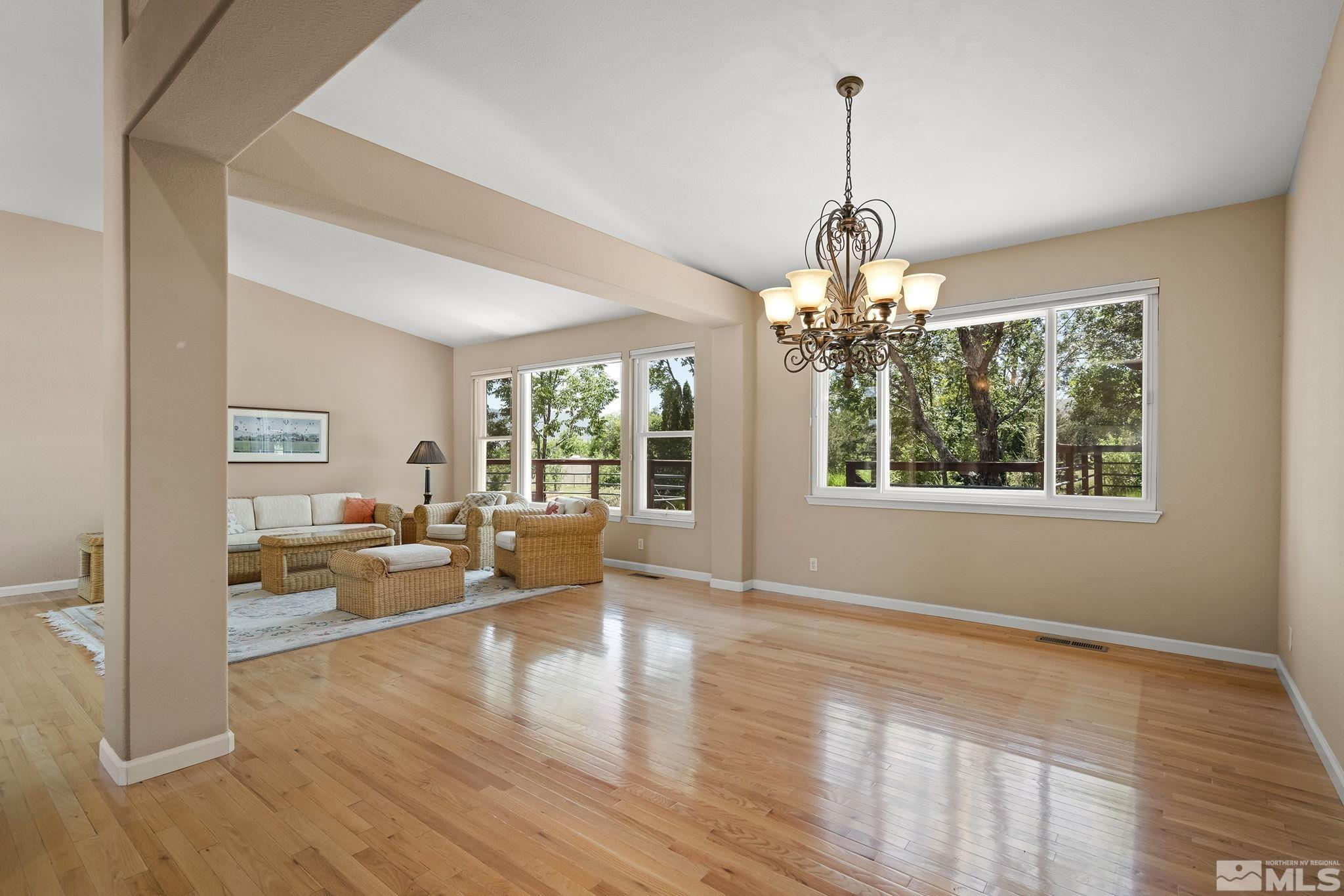 820 Flanders Road Reno, NV 89511 - Photo 8 of 40 a view of a livingroom with wooden floor and a chandelier