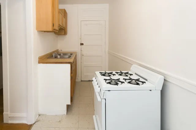a kitchen with a stove and a refrigerator