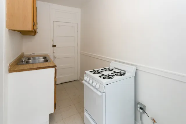 a kitchen with a stove and a refrigerator
