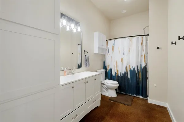 a bathroom with a double vanity sink toilet and a shower