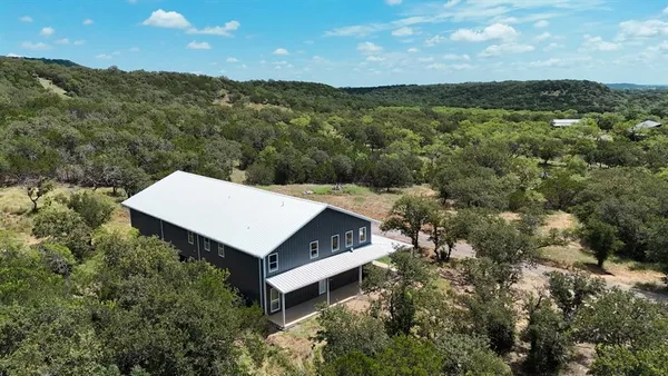 an aerial view of a house with a yard