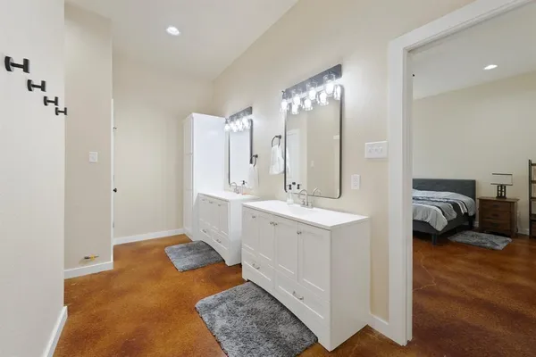 a spacious bathroom with a double vanity sink and a mirror