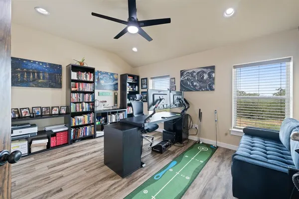 a view of a workspace with furniture and a book shelf