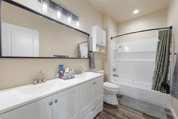 a bathroom with a sink a toilet and a mirror