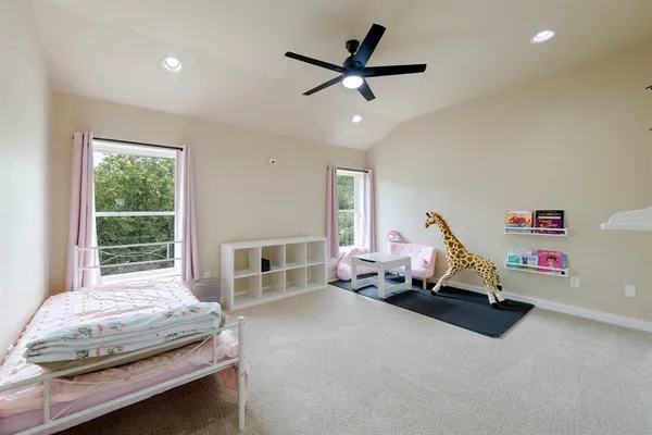 a bedroom with furniture and a large window