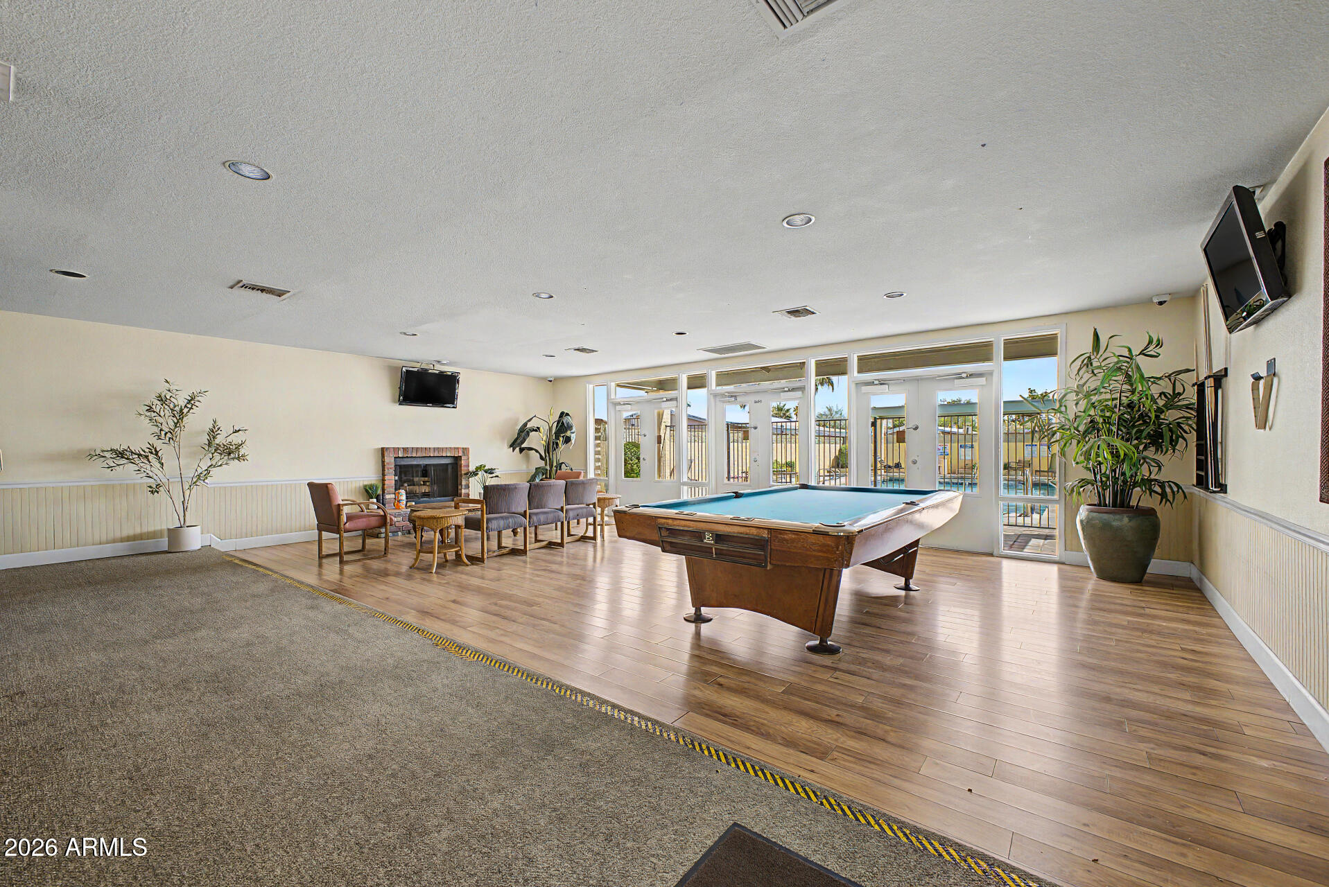 625 West McKellips Road, Unit 55 Mesa, AZ 85201 - Photo 19 of 21 a living room with furniture a rug and a flat screen tv