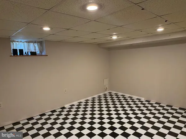 a bathroom with a black white checkered floor