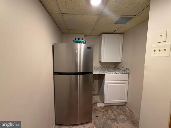 a white refrigerator freezer sitting in a kitchen