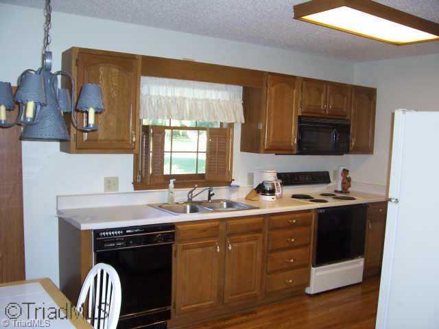 8396 Coachman Lane Rural Hall, NC 27045 - Photo 2 of 9 Other. Kitchen with range oven, built in microwave, and dishwasher.