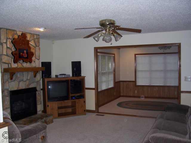 8396 Coachman Lane Rural Hall, NC 27045 - Photo 9 of 9 Other. Living room has rock fireplace with gas logs.