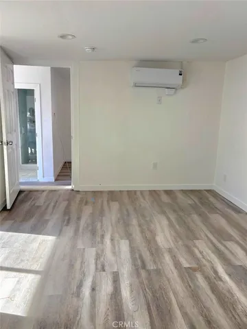 a view of a room with wooden floor