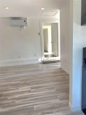 a view of a room with wooden floor