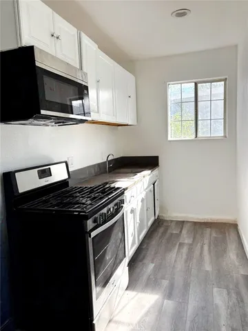 a kitchen with a stove and a microwave