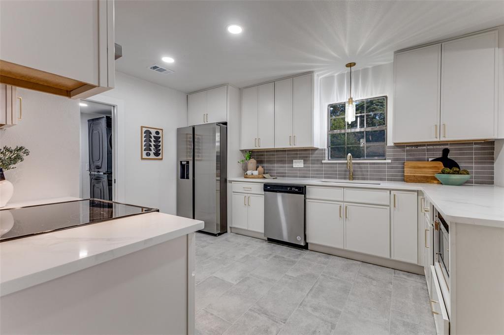 5848 Kenwood Avenue Dallas, TX 75206 - Photo 13 of 32 a kitchen with a refrigerator sink and cabinets