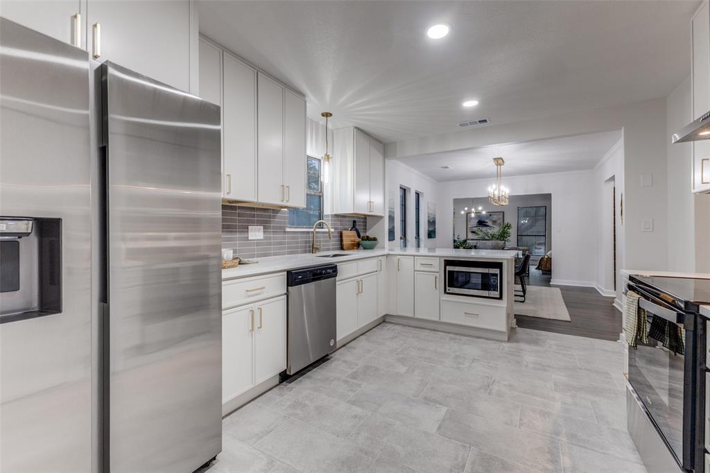 5848 Kenwood Avenue Dallas, TX 75206 - Photo 14 of 32 a kitchen with white cabinets and appliances