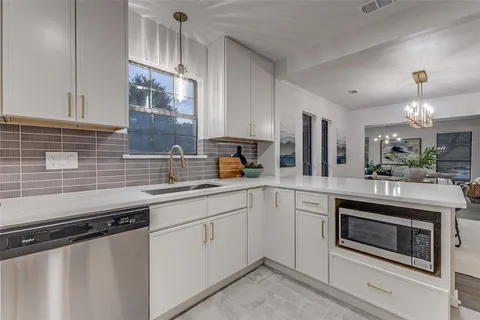 a kitchen with a sink stove and microwave