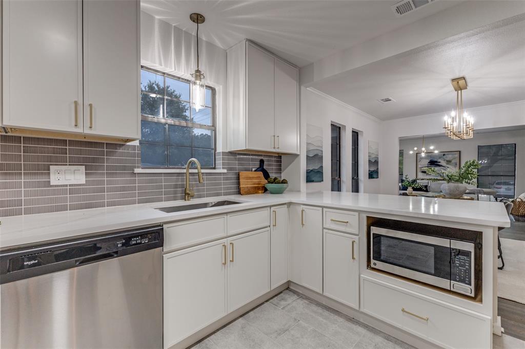 5848 Kenwood Avenue Dallas, TX 75206 - Photo 15 of 32 a kitchen with a sink stove and microwave