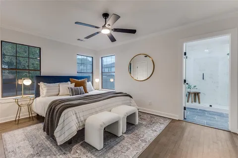 a bedroom with a large bed and a chandelier