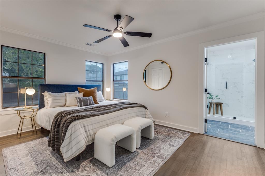 5848 Kenwood Avenue Dallas, TX 75206 - Photo 16 of 32 a bedroom with a large bed and a chandelier