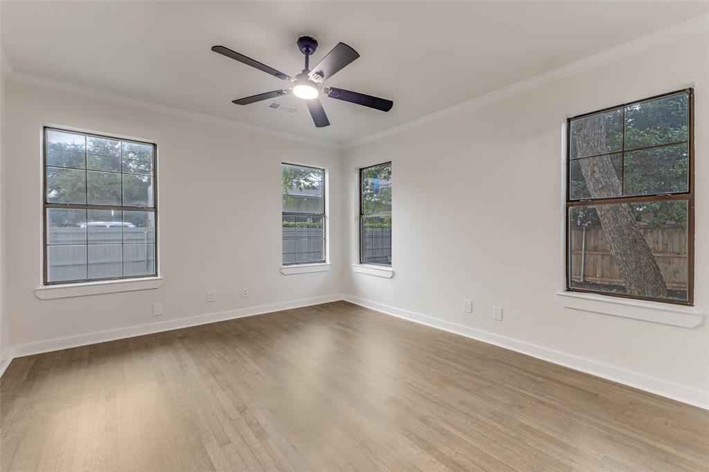 5848 Kenwood Avenue Dallas, TX 75206 - Photo 23 of 32 a view of an empty room with wooden floor and a window