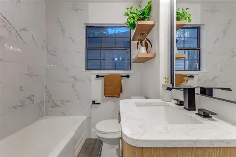 a bathroom with a sink toilet and bathtub