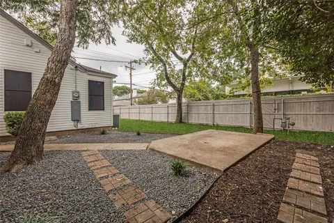 a view of a backyard with large trees