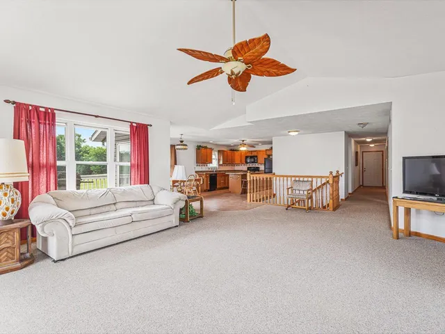 a kitchen with stainless steel appliances granite countertop a sink a stove and a refrigerator