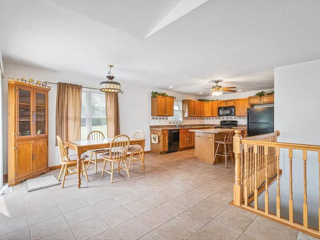 a view of a hallway with furniture and a fireplace
