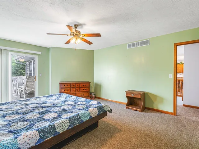 a bedroom with a bed dresser and a window