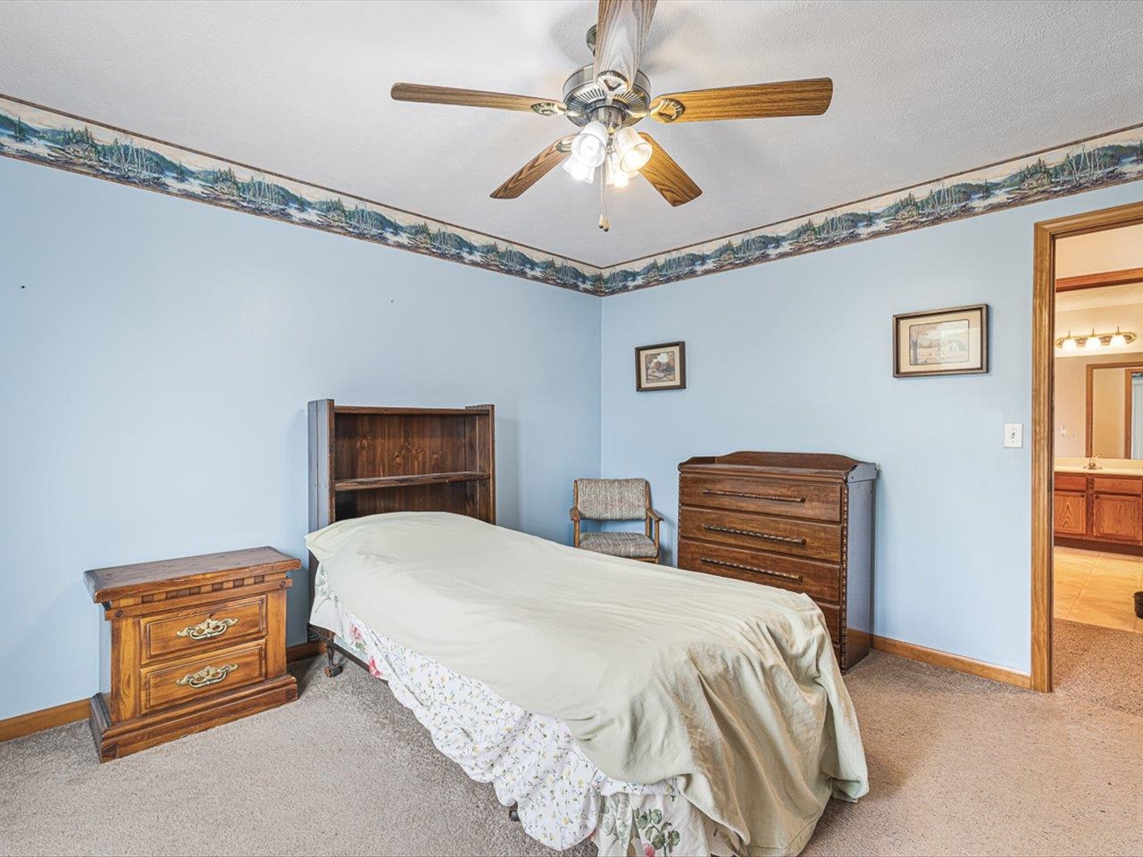 1106 Drexel Road Lake Summerset, IL 61019 - Photo 25 of 43 a bedroom with a bed and a chandelier